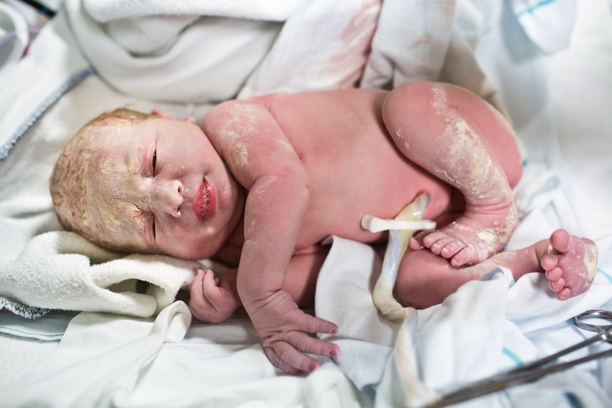 Newborn baby with umbilical cord