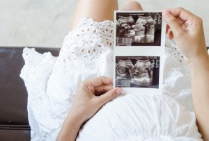 pregnant woman looking at ultrasound picture