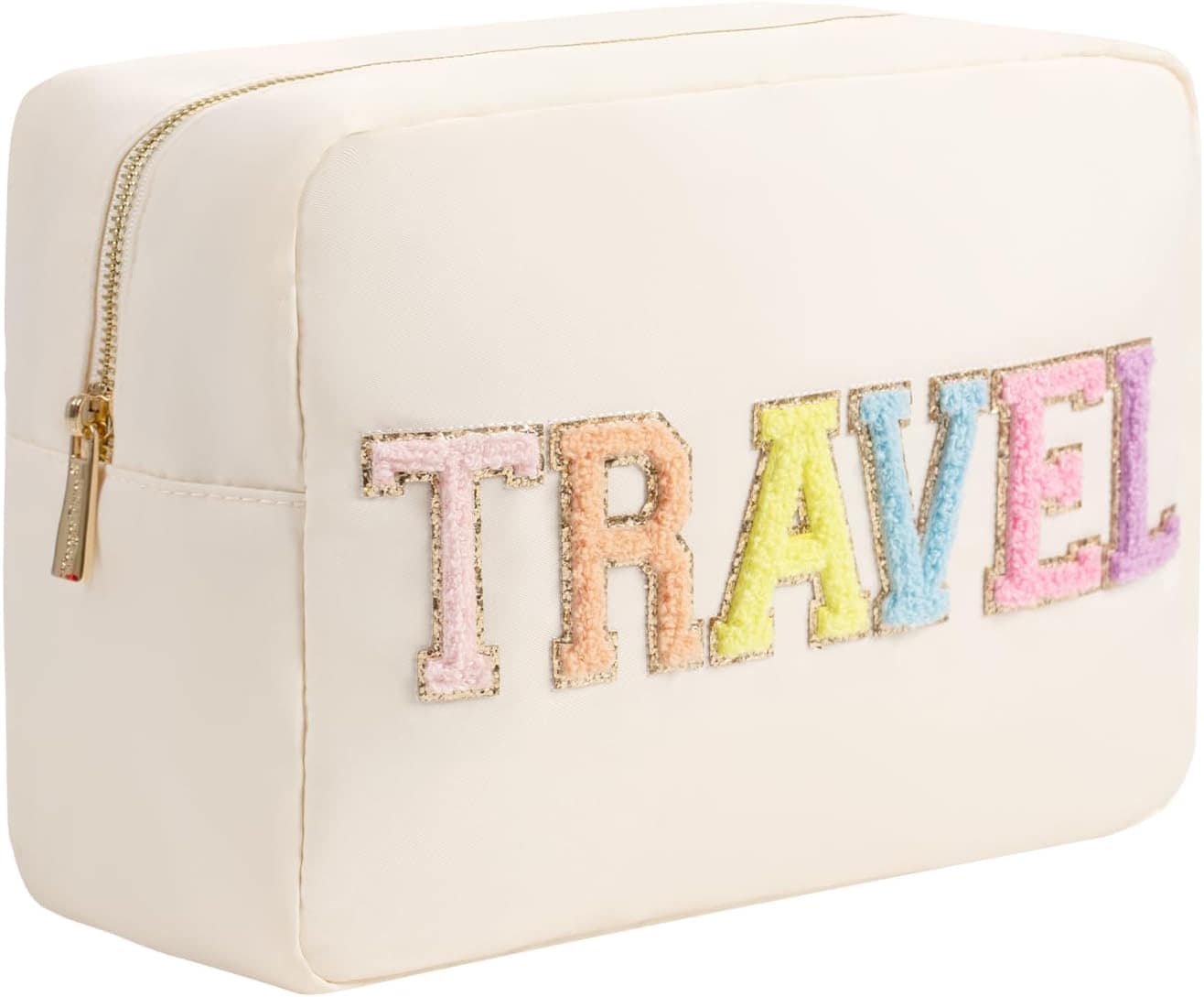 A cream-colored travel bag with a gold zipper. It features the word "TRAVEL" in large, multicolored, textured letters on the front, making it an ideal accessory or even a unique DIY baby shower gift.