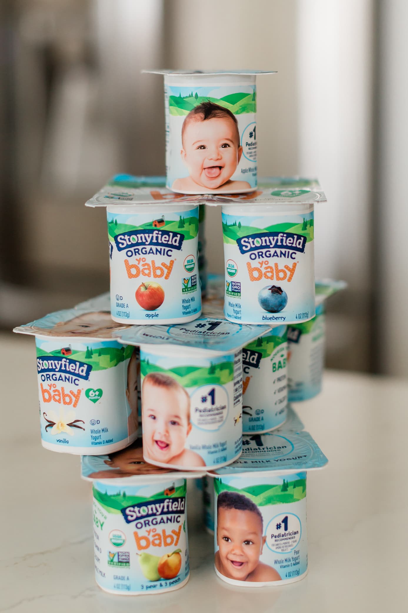 stack of Stonyfield yobaby yogurts on a kitchen counter