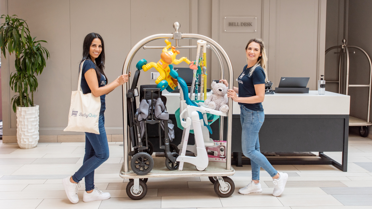Two women from BabyQuip delivering baby rented items