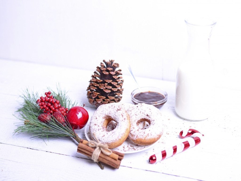 Christmas donuts on white wooden table