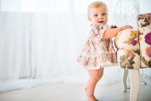 One year old girl taking first steps