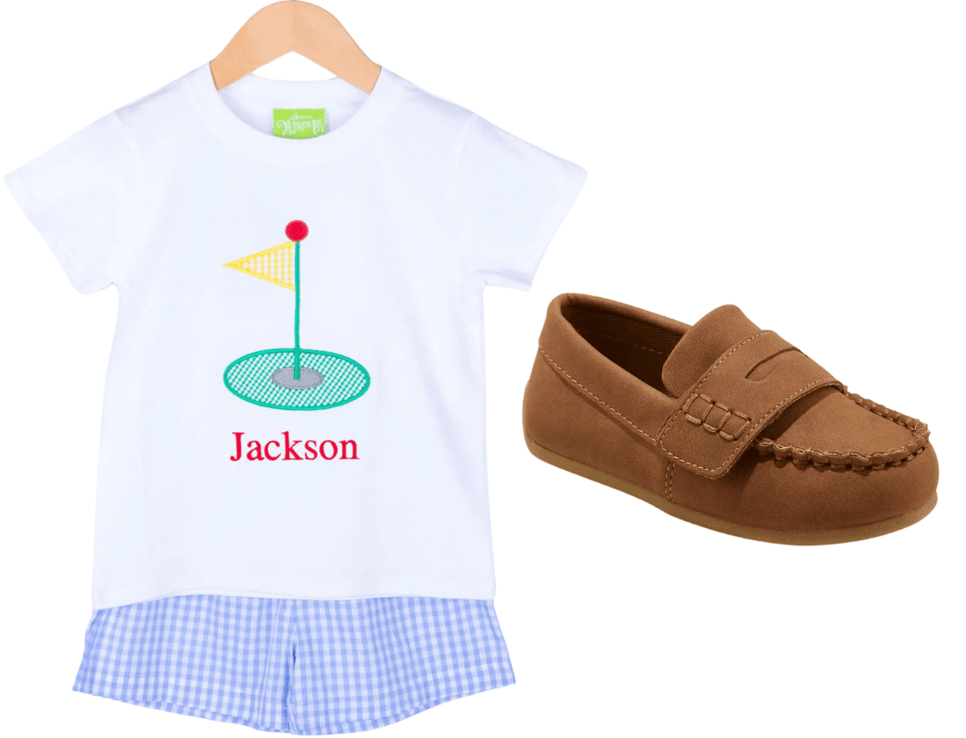Boys golf t-shirt and blue and white plaid shorts next to brown loafers 