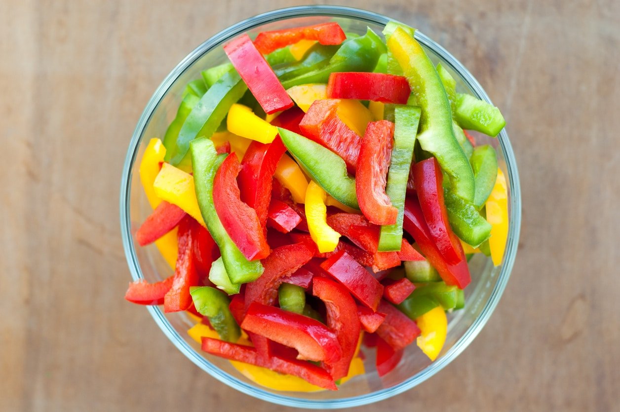 Colored peppers mixed in a glass bowl