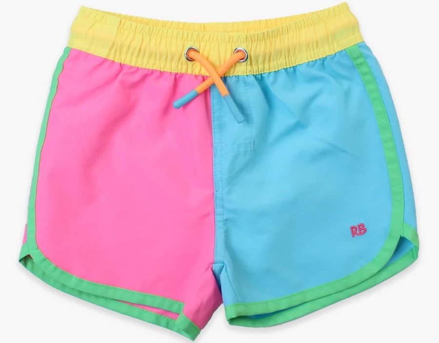 Sure! Here is your text with all single quote and double quote characters removed: A pair of childrens swim trunks with a pink left side, blue right side, yellow waistband, green trim, and orange drawstring. The embroidered red RB on the blue side makes these trunks true summer must-haves.