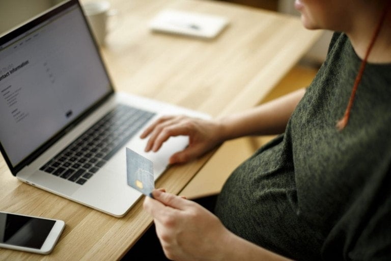 Pregnant woman shopping online on her laptop