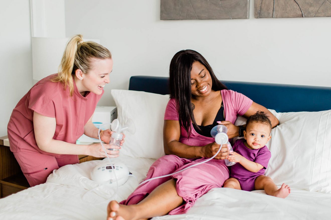 Mom with her postpartum doula and daughter using the Motif Luna breast pump.