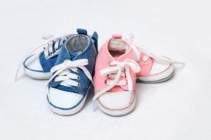 Pink and blue baby shoes arrangement.
