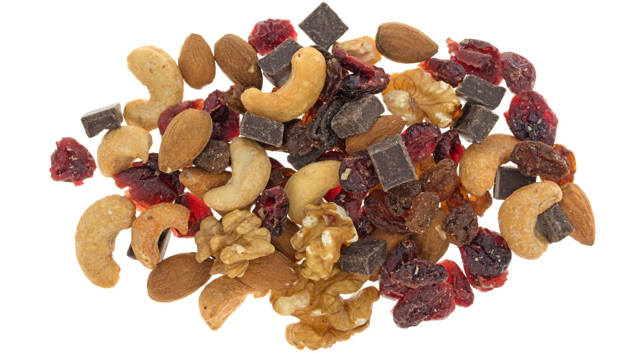 Top view of a serving of chocolate trail mix isolated on a white background.