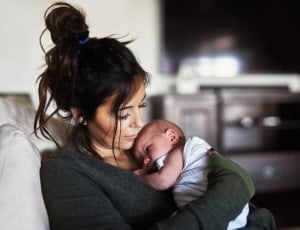 Shot of a young woman holding her little infant son at home during the day