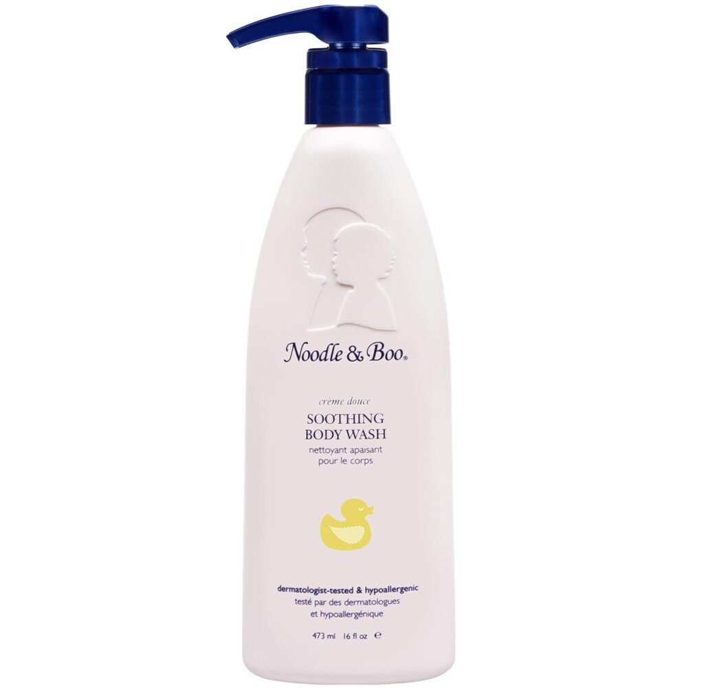 A white bottle of Noodle & Boo Soothing Body Wash with a blue pump top. The bottle features an embossed logo of two faces and a yellow rubber duck illustration, ideal for postpartum recovery. The product is 473 ml (16 fl oz), dermatologically-tested, and hypoallergenic.