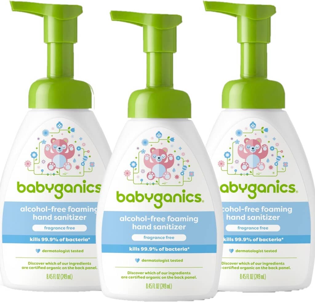 Three bottles of Babyganics alcohol-free foaming hand sanitizer, each with a green pump dispenser and a label showing an illustration of a pink teddy bear and green leaves. Essential for postpartum recovery, this product claims to kill 99.9% of bacteria and is fragrance-free.
