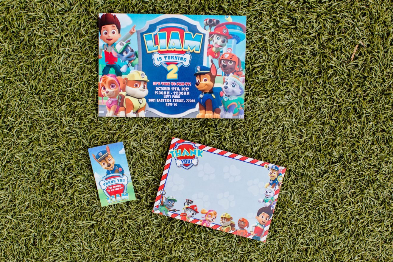 Paw Patrol birthday invitation, thank you tag and thank you card on the grass.