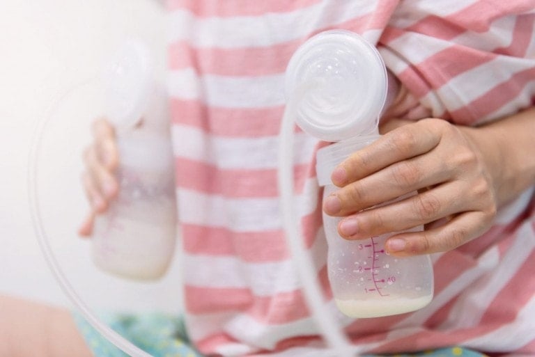 Mom start pumping milk to bottles by Automatic breast pump machine. breastmilk is the best healthy nutrition food for newborn baby. Motherhood and baby healthcare concept.