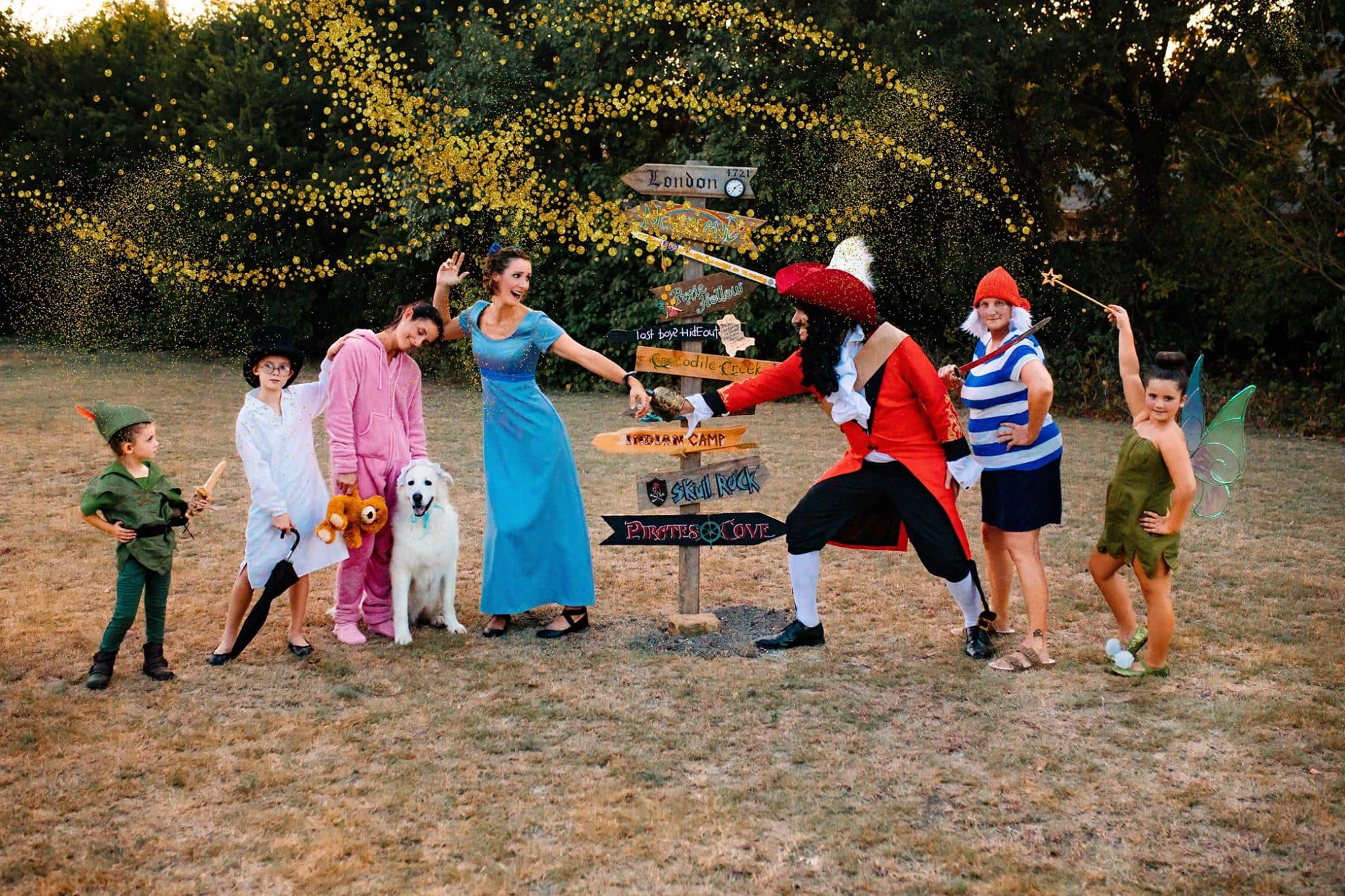 peter pan family costume with captain hook, smee, tinker bell, peter pan, wendy, john, michael, and nana