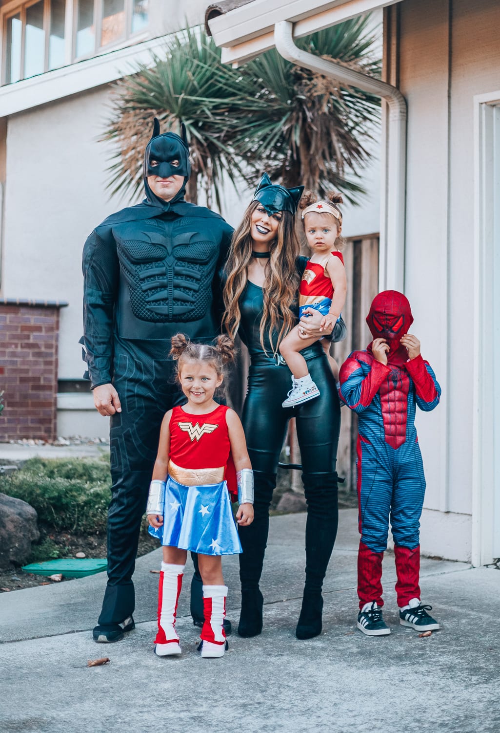 superhero family costumes with batman, catwoman, wonder woman, and spiderman
