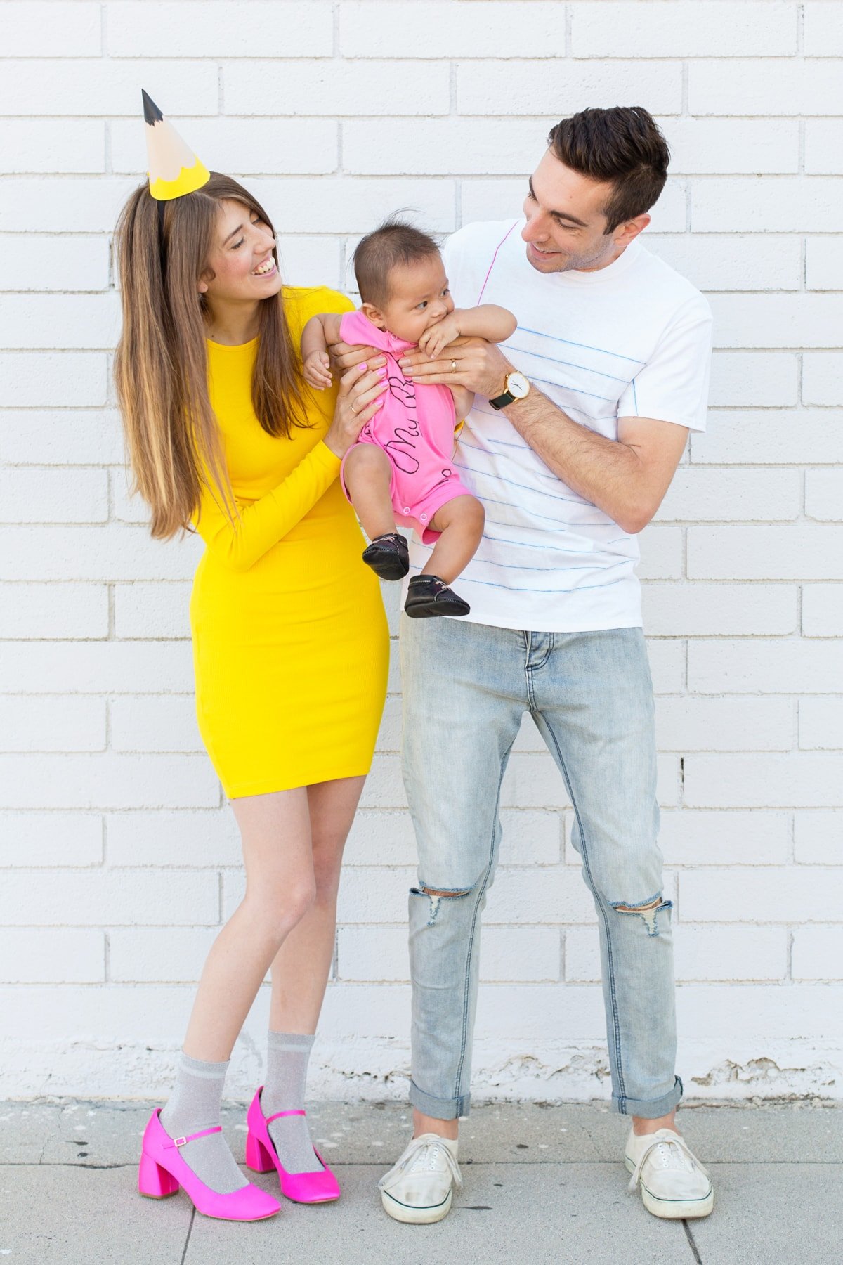 family school supplies costume, with mom dressed as a pencil, dad dressed as paper, and baby dressed as an eraser