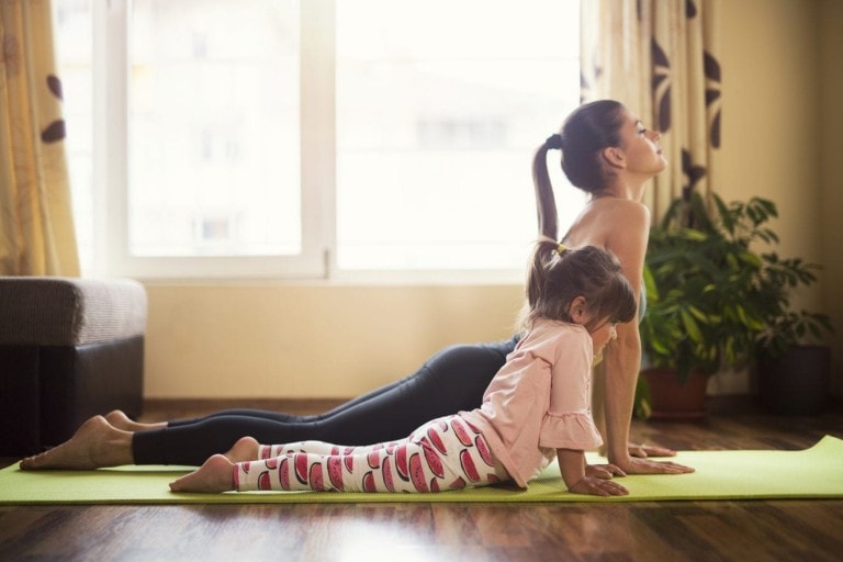 Full length shot of a mother and daughter doing yoga together