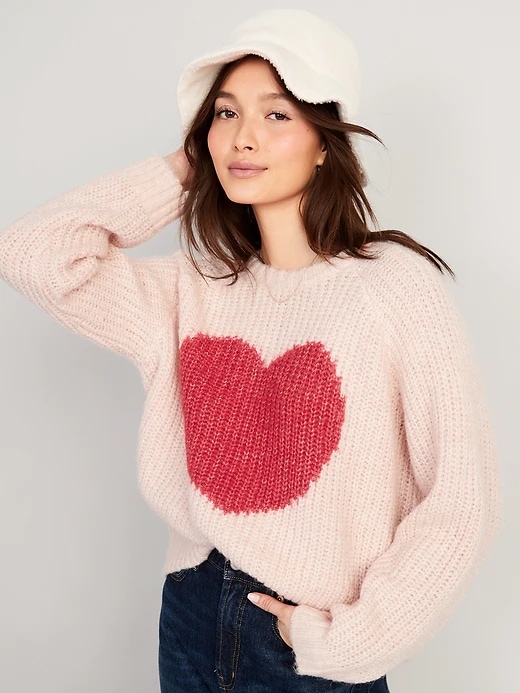 Woman in pink sweater with red heart in the middle 
