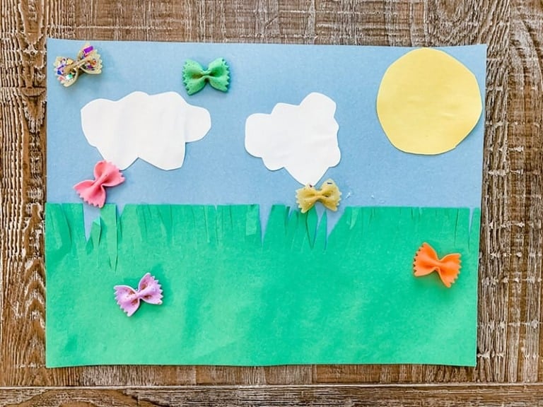 A kid's craft using pasta, paint and construction paper.