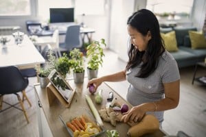 Asian woman at home making a healthy meal
