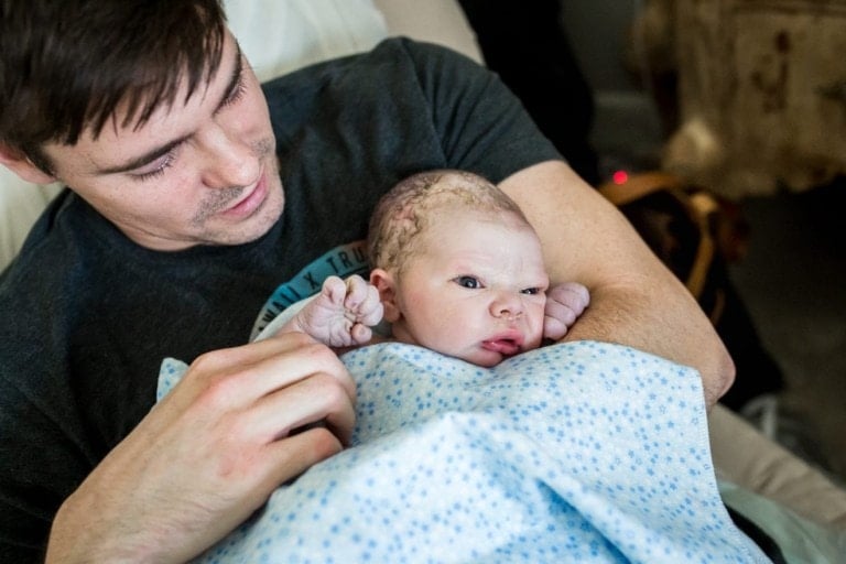 Brian Spears, Co-Founder of Baby Chick, holding his newborn son, Liam.