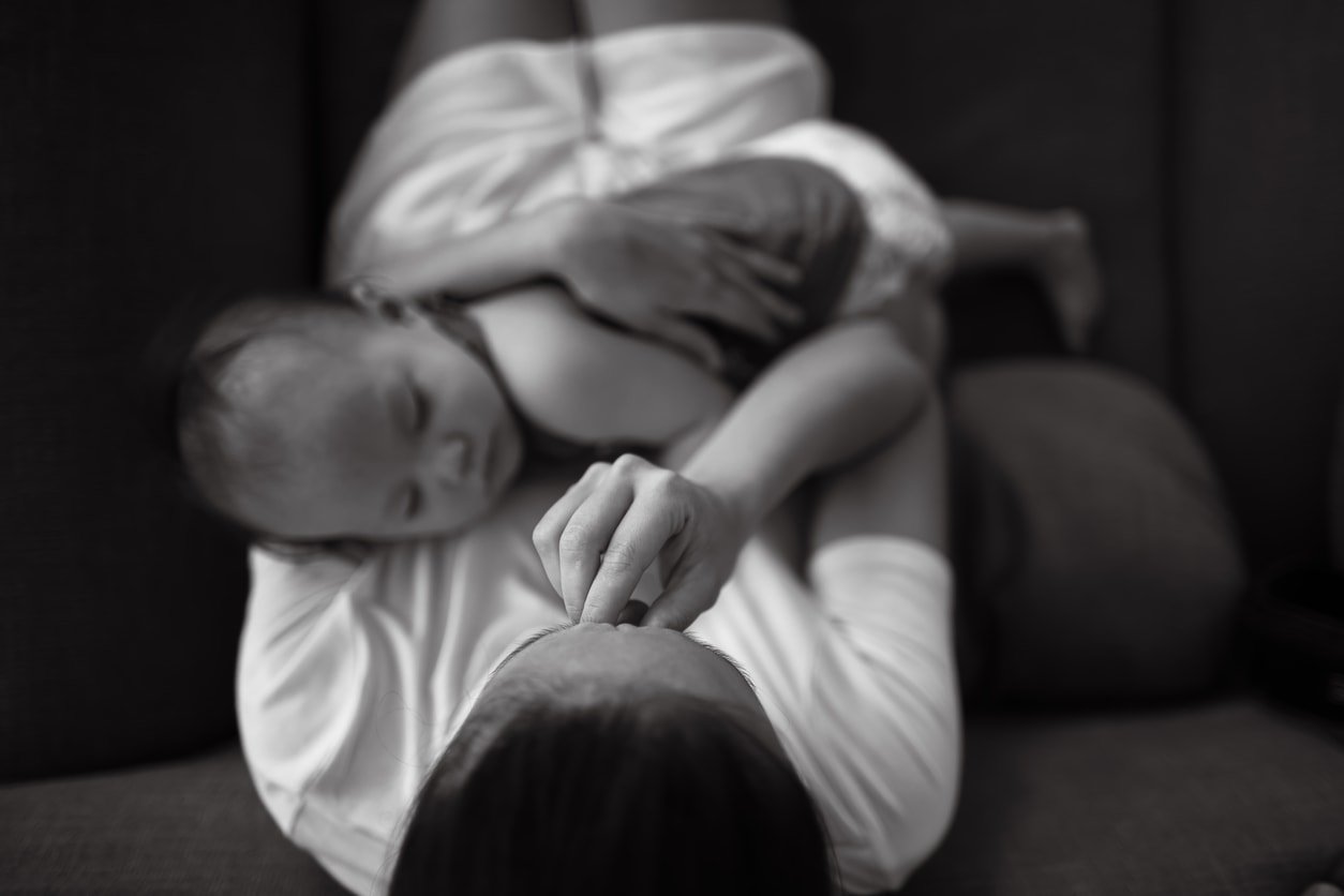 Tired and stressed out mother holding her baby. Black and white image.