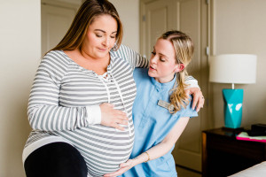 Doula helping an expecting mom during labor.