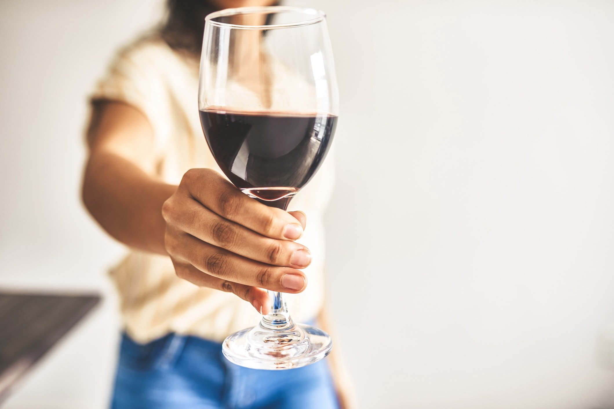 Cropped shot of an unrecognizable woman holding a glass of wine