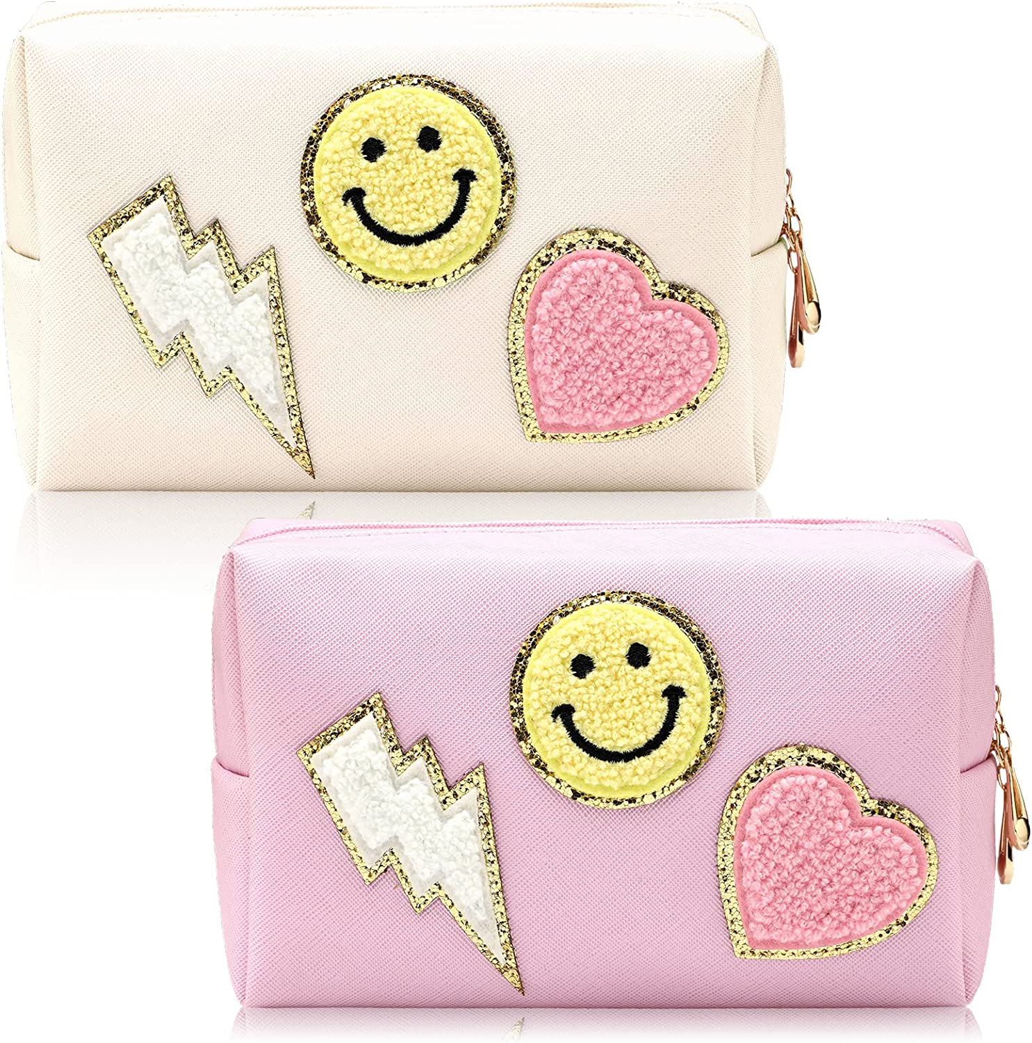 Two pouches with a heart, smiley face, and lightening bolt patch on them in pink and white 