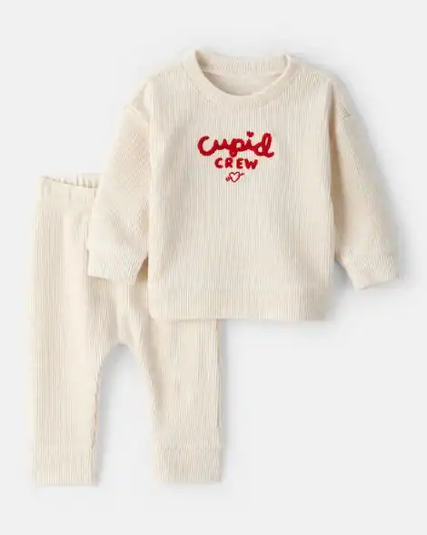 Baby Valentine's Day outfit with "Cupid Crew" sweater and matching pants.