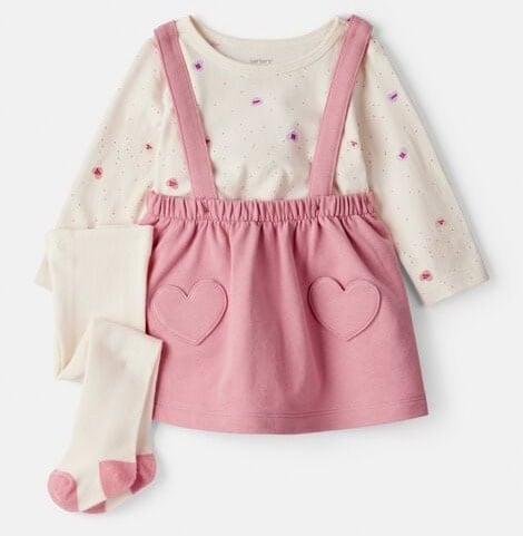 Baby girl Valentine's Day outfit with pink dress, heart pockets, and matching tights.