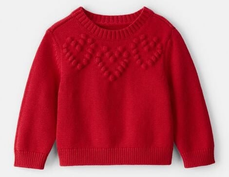 Baby girl red Valentine's Day sweater with heart patterns.