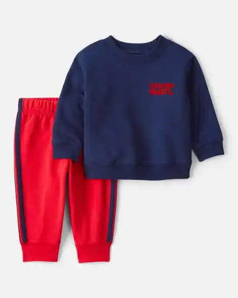 Baby Valentine's Day outfit with navy sweatshirt and red pants.