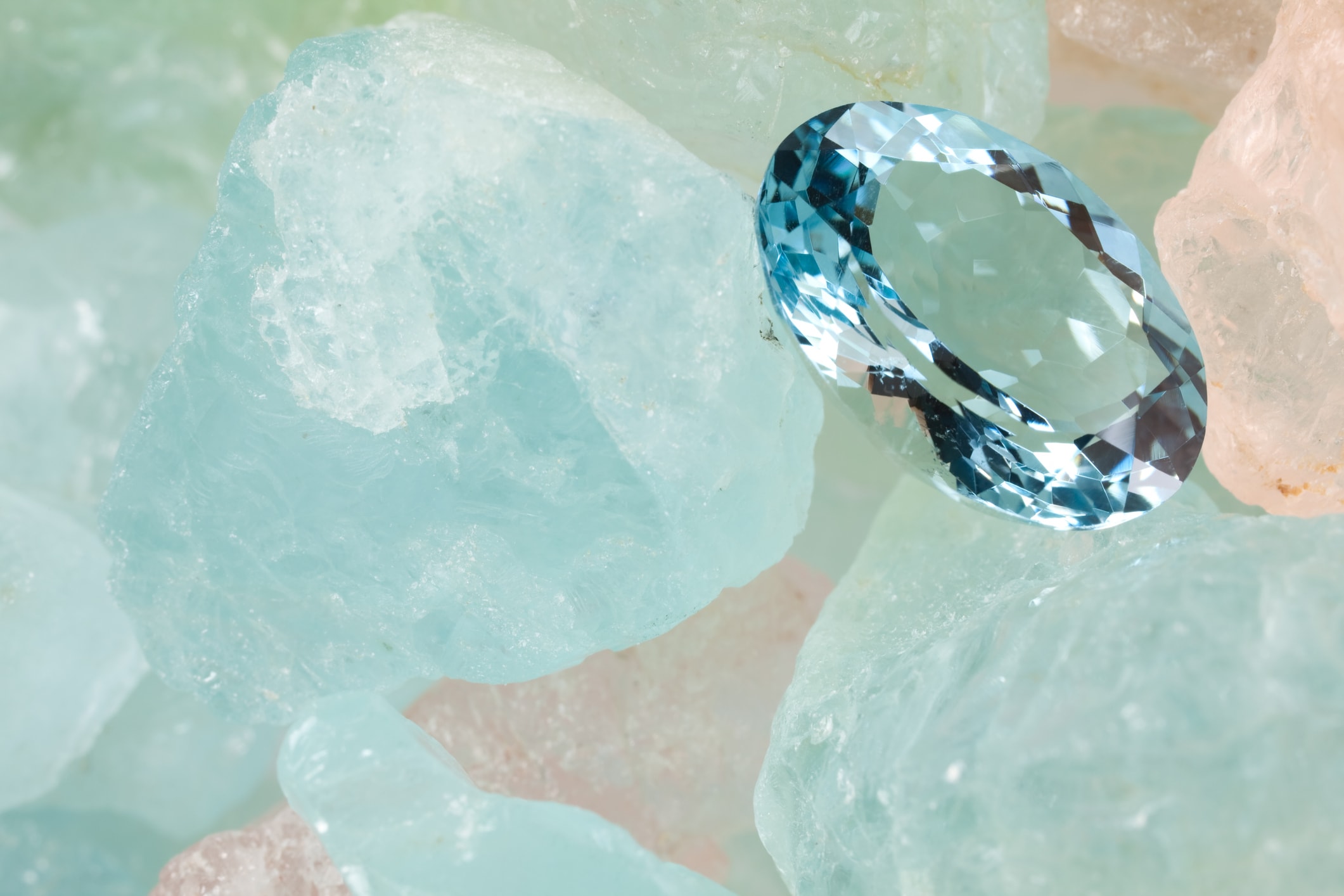 Polished aquamarine is on rough aquamarine gems.