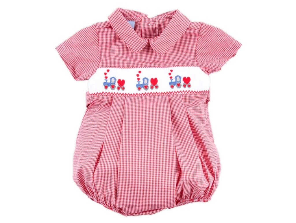 Adorable pink Valentine's Day baby romper with train and heart details.