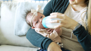 A new mom bottle feeding a newborn