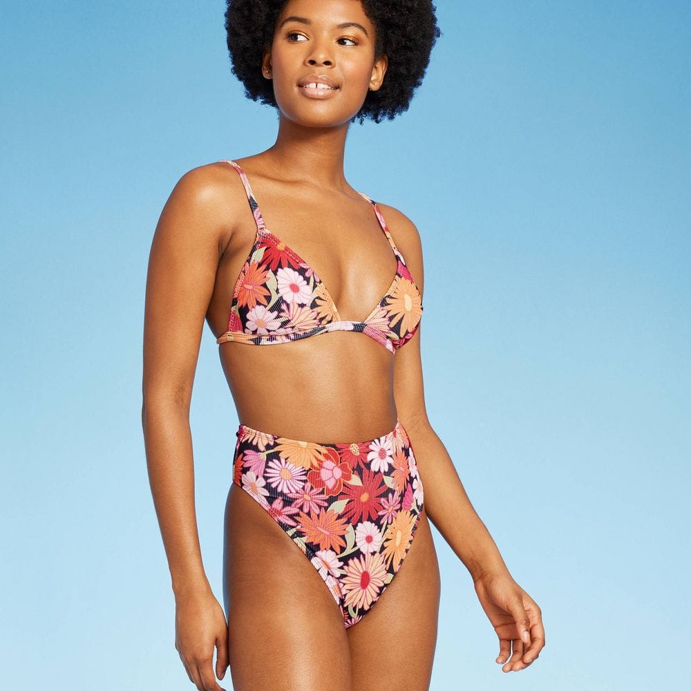 Woman in two-piece floral print bathing suit with high-waisted bottoms 