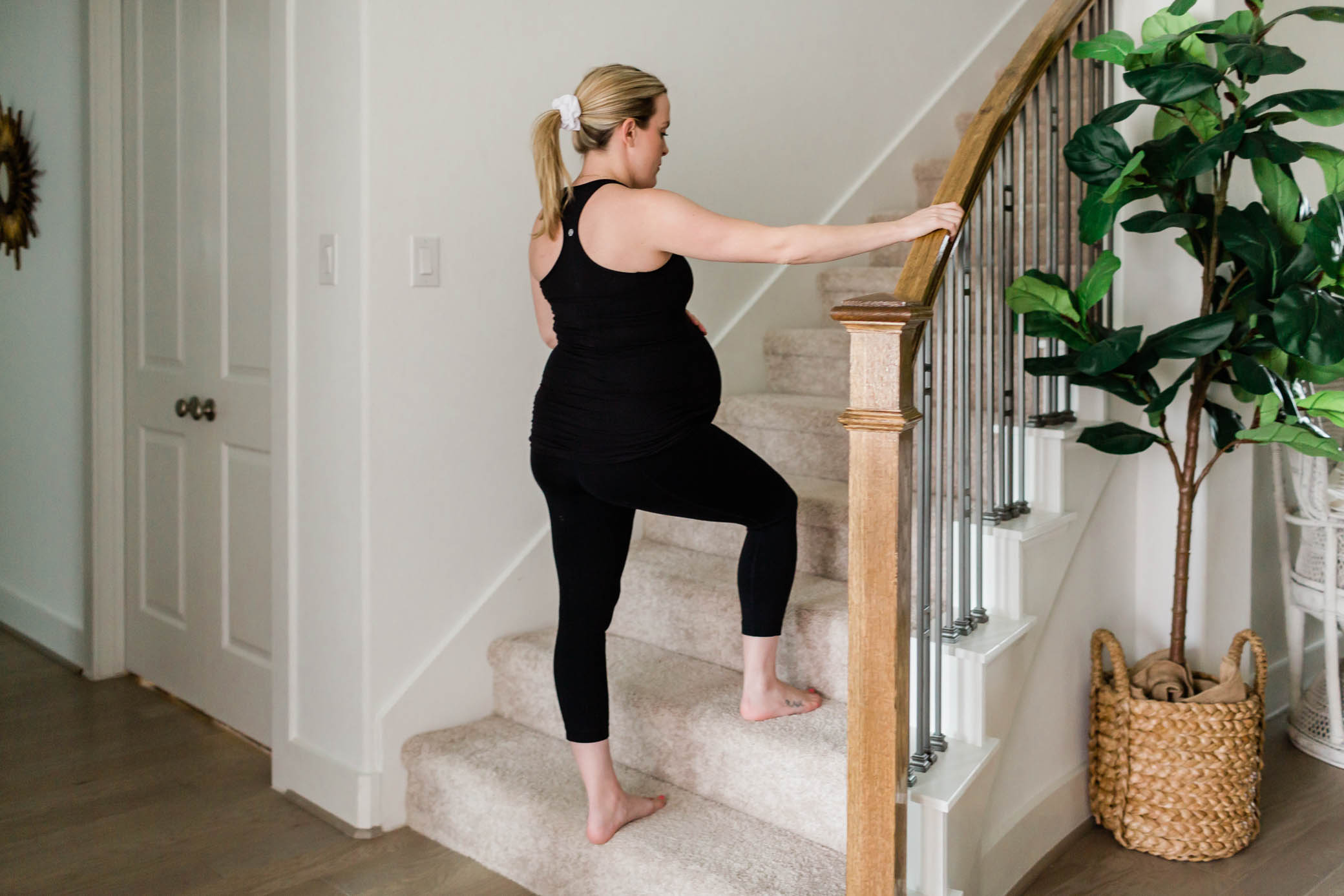 Pregnant woman walking up stairs.