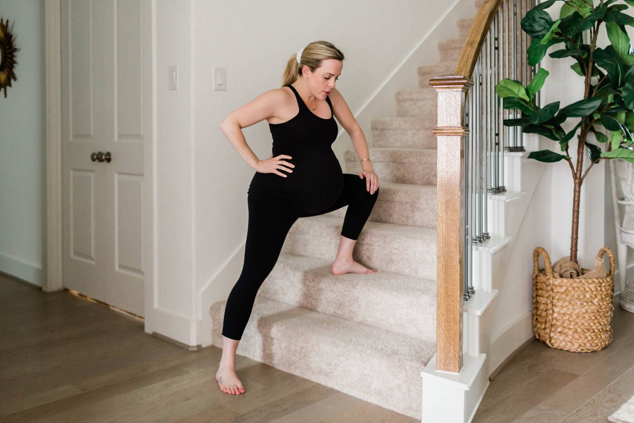 Pregnant woman lunging on the staircase.