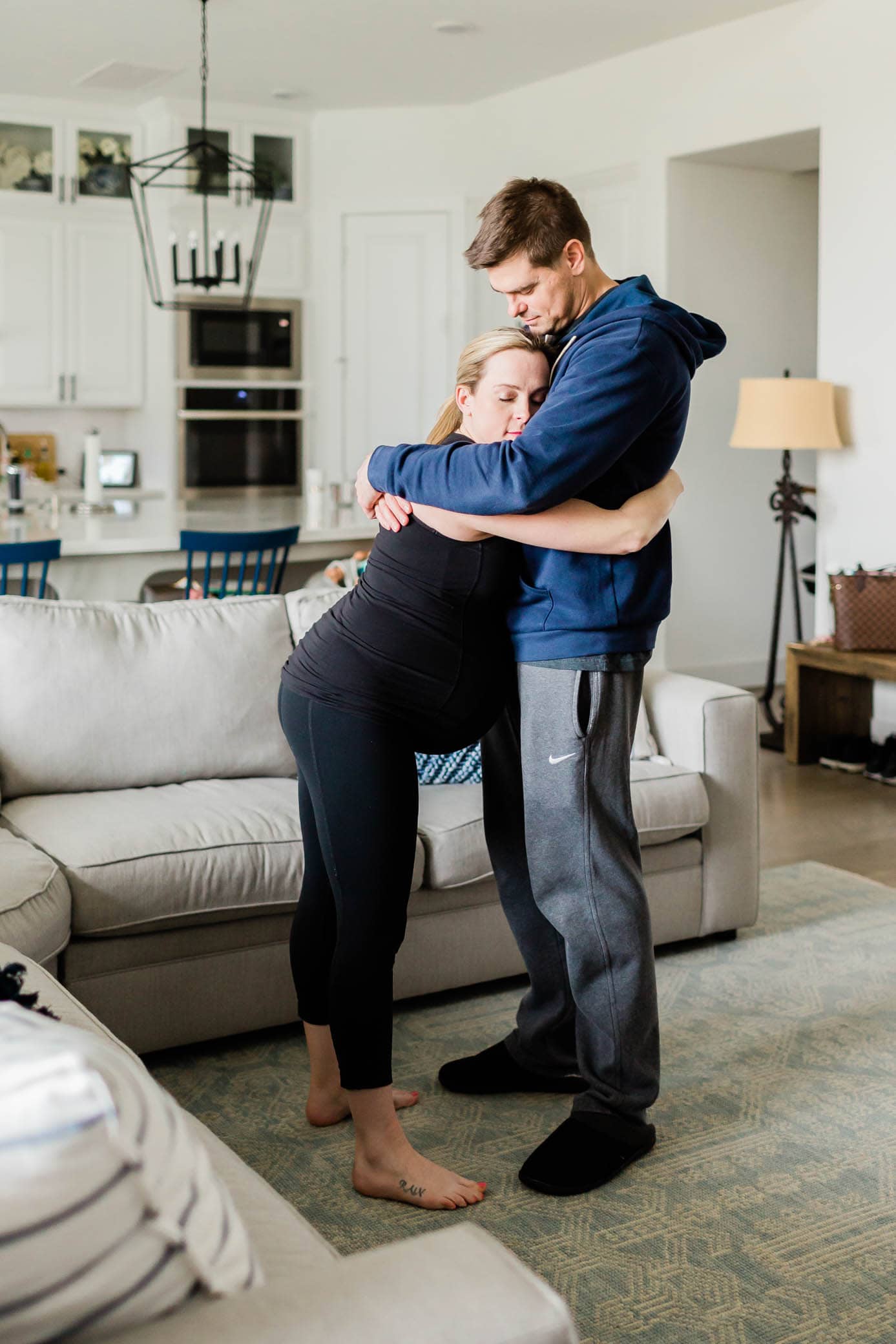 Pregnant woman slow dancing with her partner in labor.