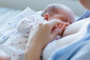 Newborn baby breastfeeding.