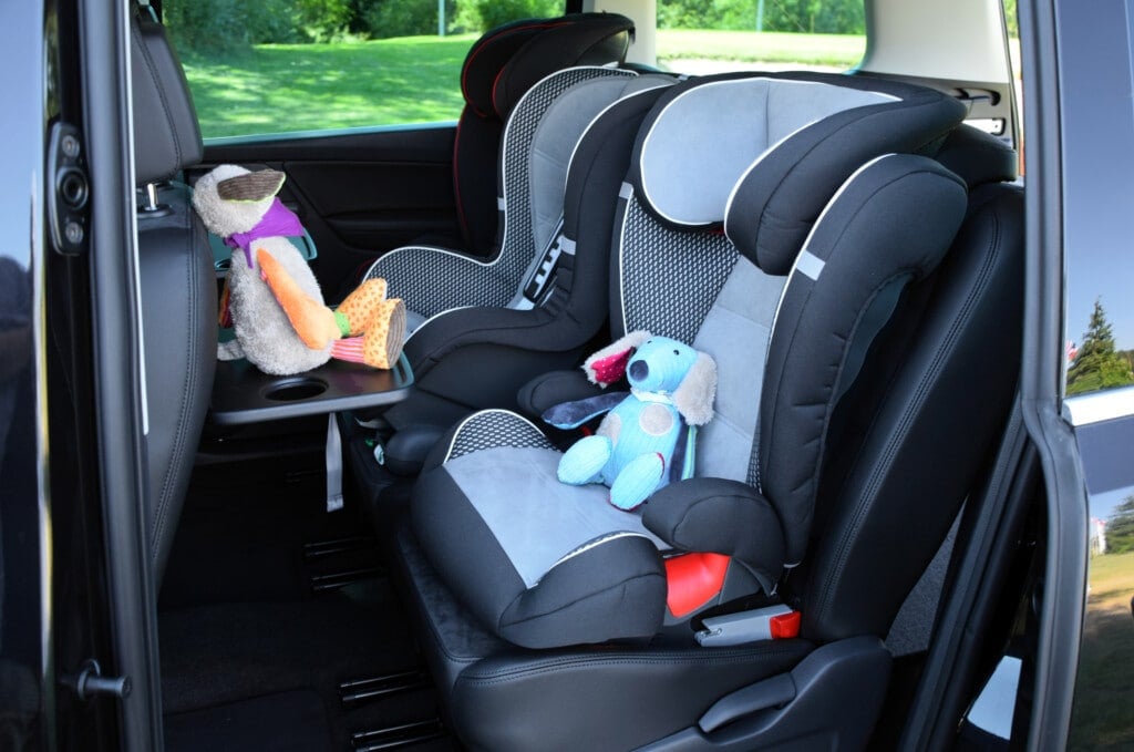 Side shot on the car seats for children mounted in a minivan.