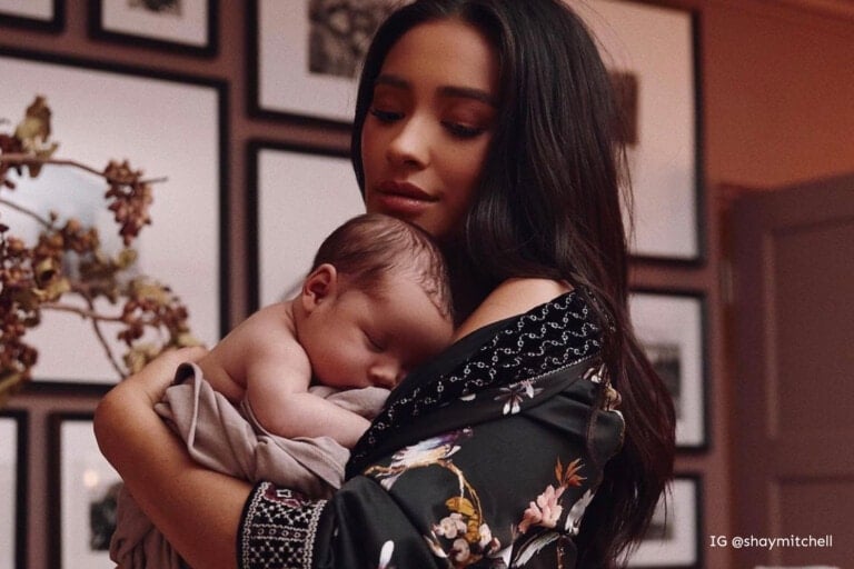 Shay Mitchell holding her baby boy Atlas in his nursery.