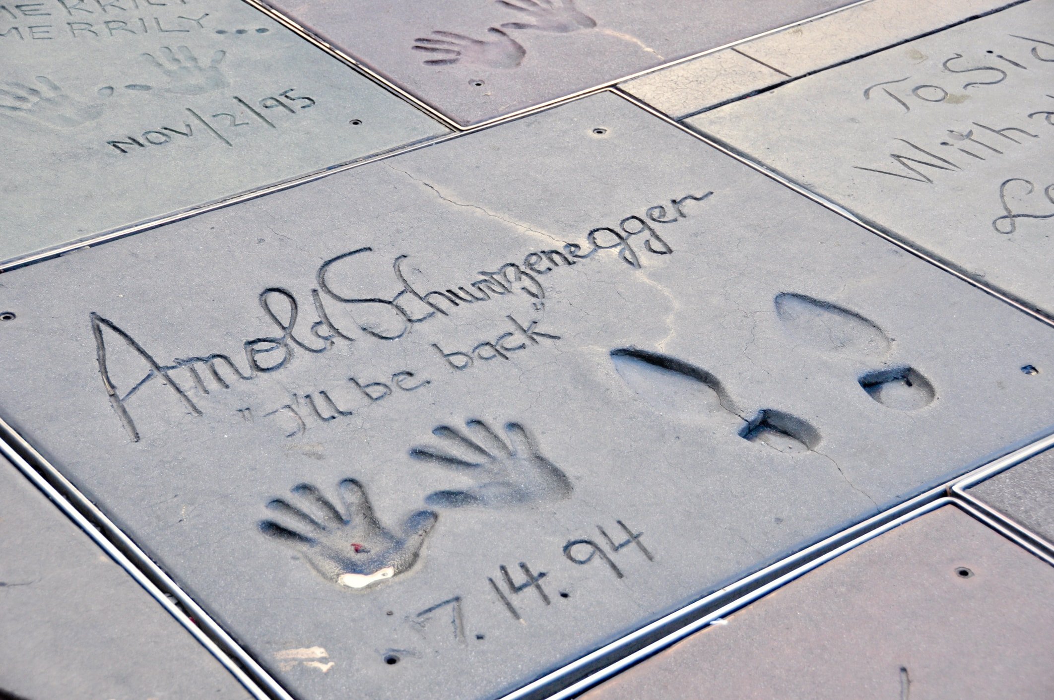 Arnold Schwarzenegger's Hand Print at Mann's Chinese Theater. The Shoe prints and handprints in concrete and dated 7.14.94.