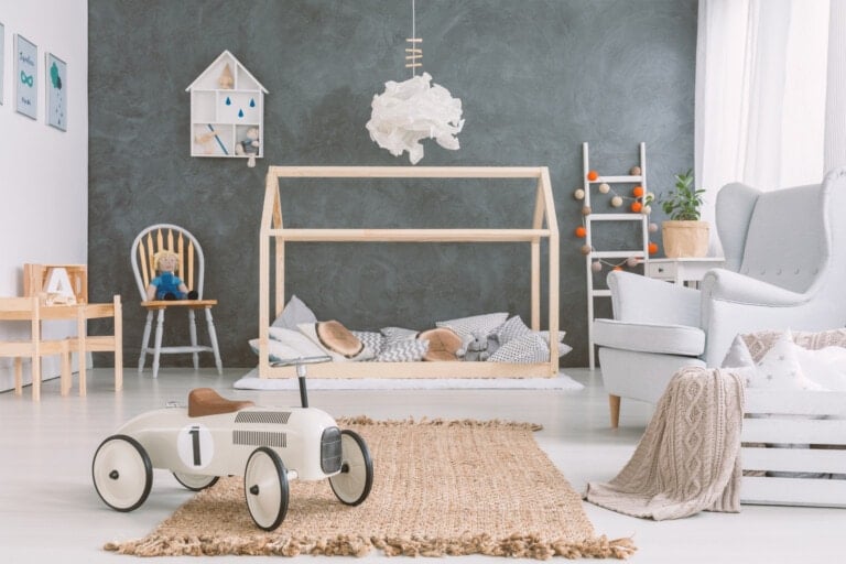Baby room in scandinavian style with armchair and wood bed