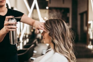 Beautiful brunette woman with long hair at the beauty salon getting a hair blowing.