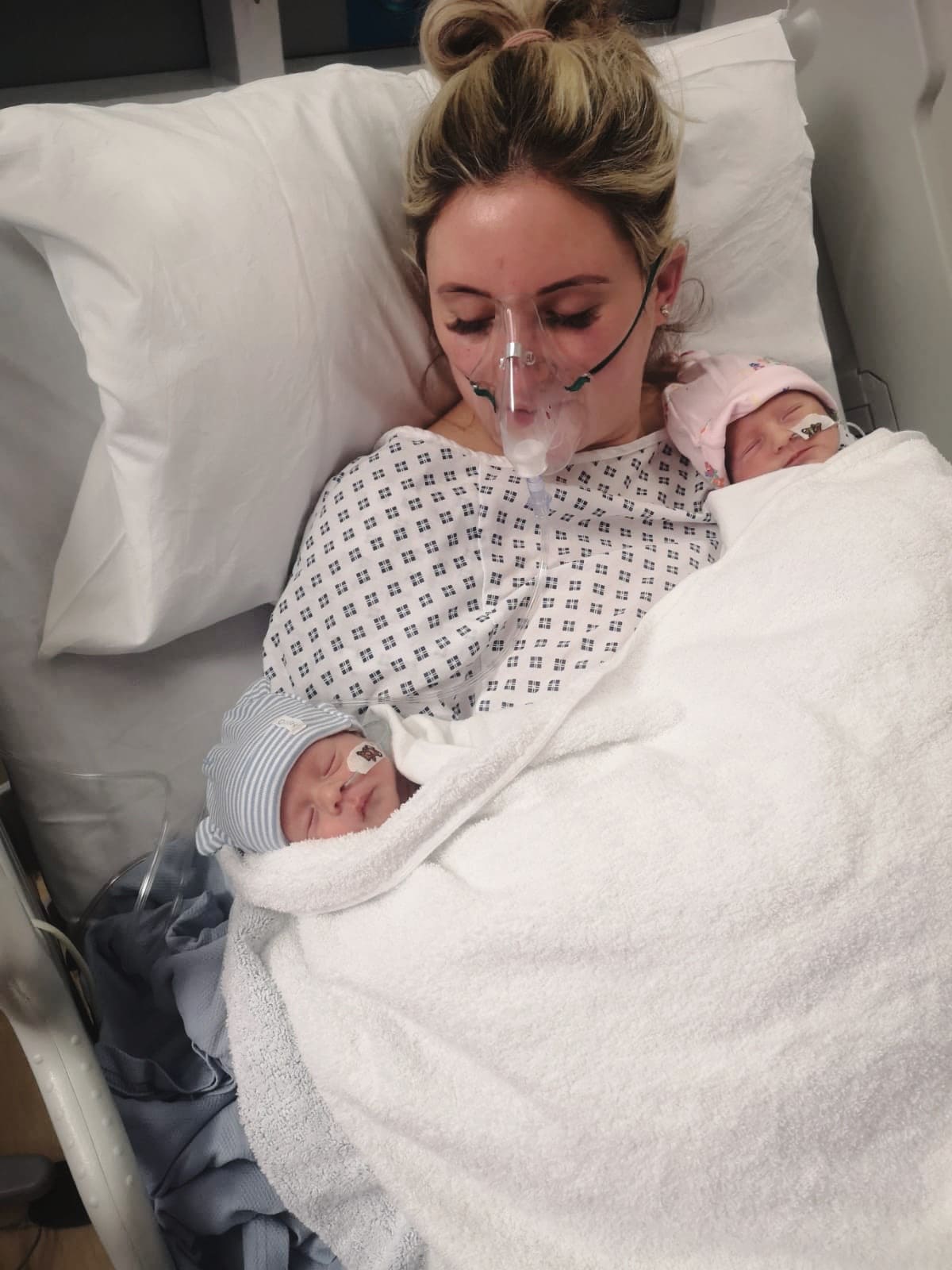 mother in the hospital with her twin babies after an emergency c-section