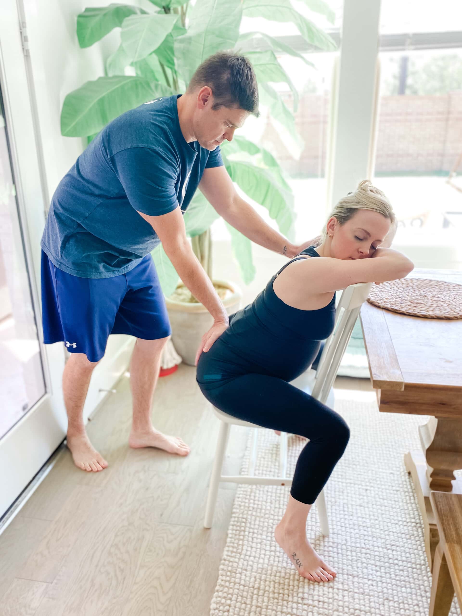 Husband doing counter pressure on his wife's lower back.